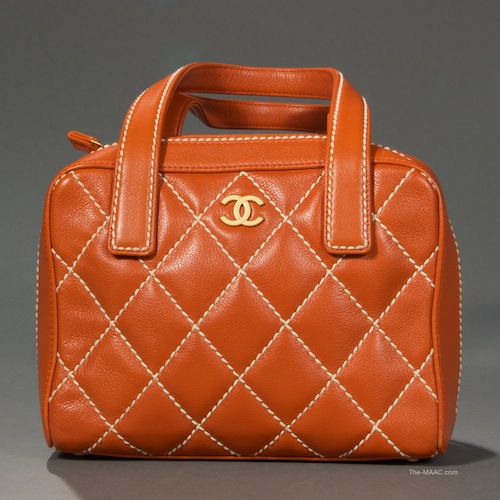 Chanel Caviar Leather Quilted Handbag. Top handle cognac color quilted Chanel handbag. Inside is a removable center section, handles have 5-1/2″ drop, double zipper opening. Caviar leather, France, 2002.