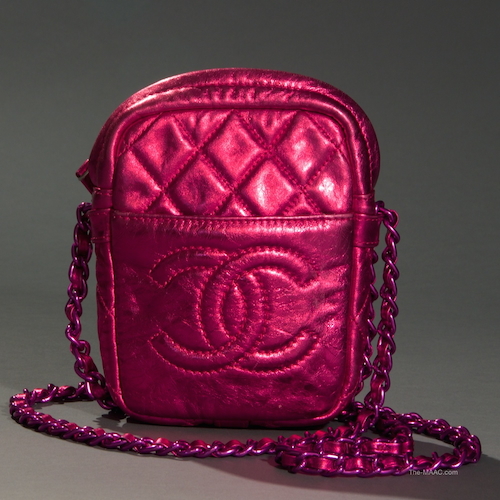 Chanel Metallic Pink Bag. This small metallic pink leather cross body bag featured a pink plated link chain that wraps around the bottom of the bag. It has an interlocking CC logo on front pocket. Leather and pink hardware, France, 2009.