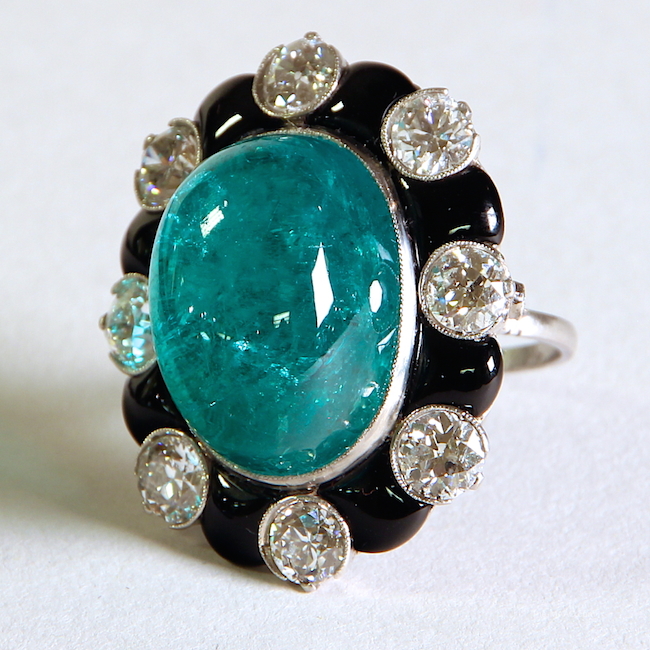 Cabochon Colombian emerald approximately 30 cts, with 8 full cut diamonds weight approximately 6.00 cts surrounded by onyx and mounted in platinum. Emerald, diamond, onyx, platinum, USA, 1030.