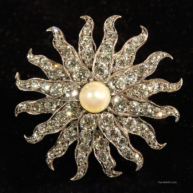 “Snowflake” style brooch with natural pearl and approximately 10 cts of full cut, old European cut diamonds, set in silver and gold. Diamond, natural pearl, set in silver and gold, USA, 1910s.