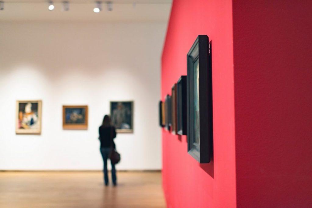 woman in museum looking at images