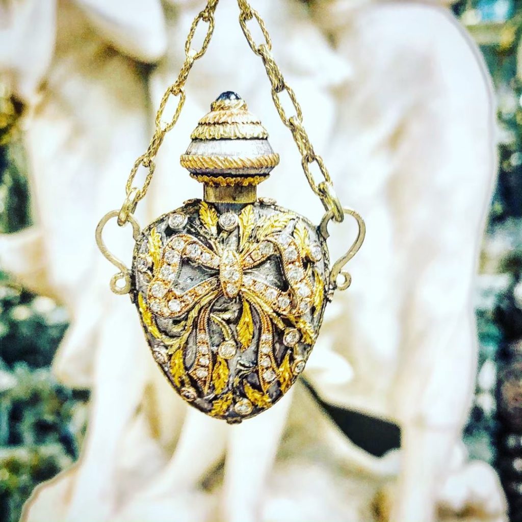 decorated gold and diamond perfume bottle, on a chain necklace