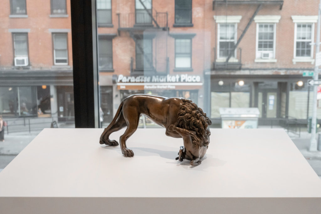 Scupture of Lion in a NYC art gallery in front of window