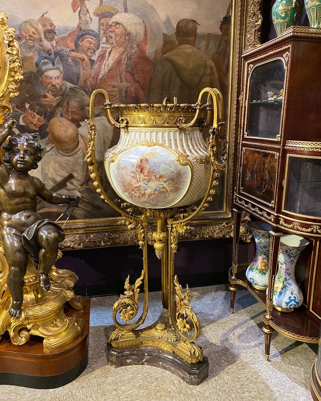 Elaborate Porcelain Jardiniere amongst other items in an antique gallery room