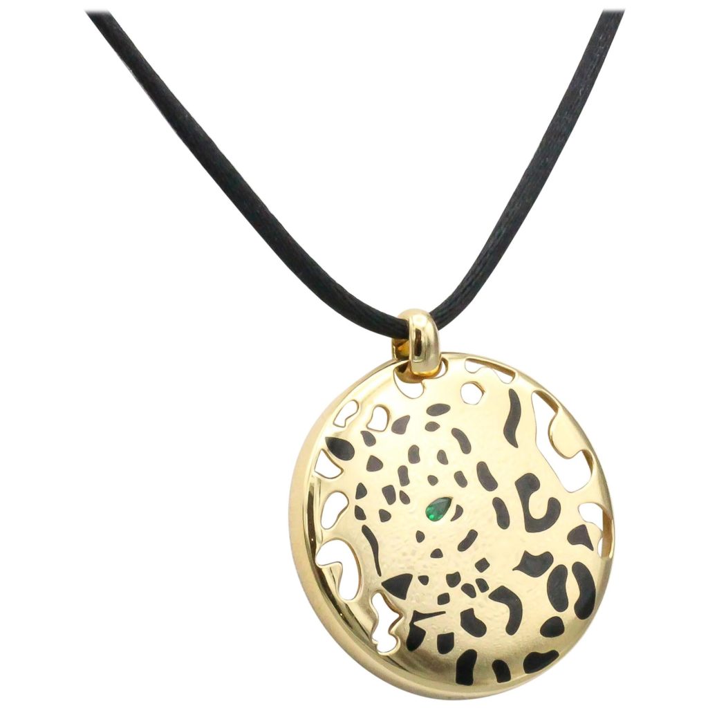 Gold Cartier pendant with a panther design with emerald eyes- on a string