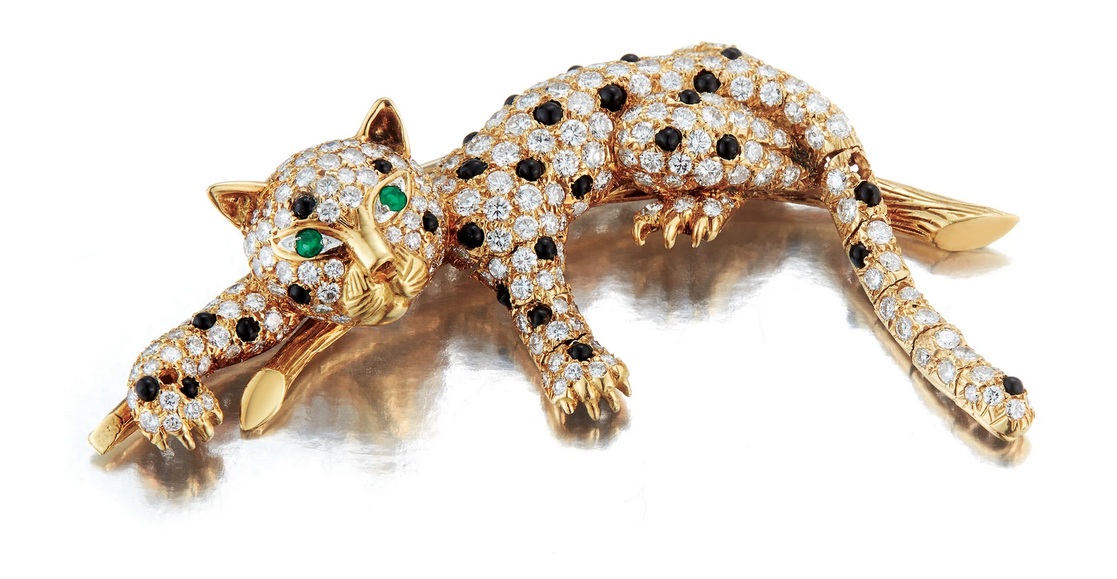 Cat brooch with diamonds and onyx on body, and emeralds for eyes